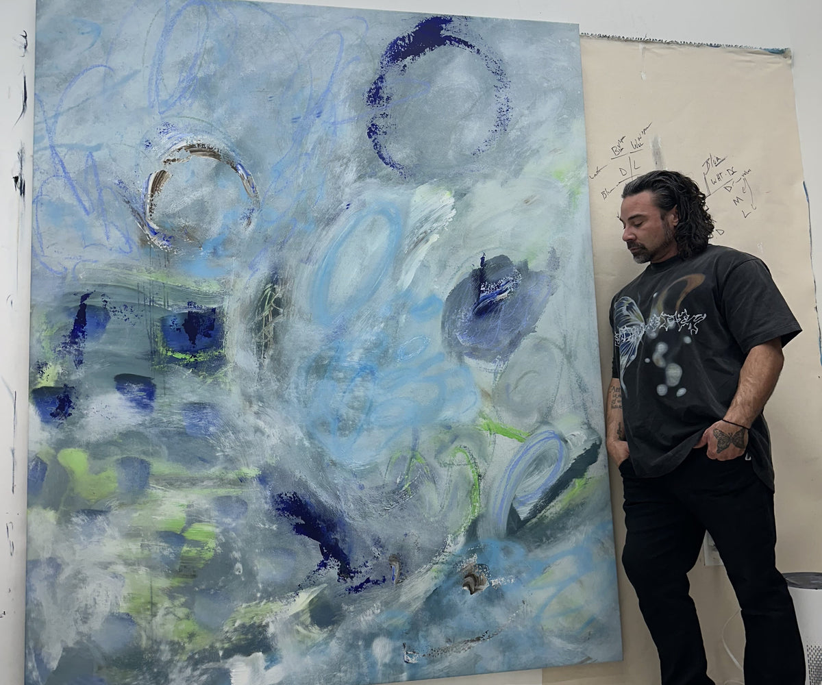 Artist creating a large-scale abstract painting in studio